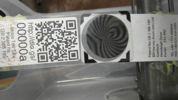 Moiré Tell Tale showing arrow fringe pattern indicating crack movement